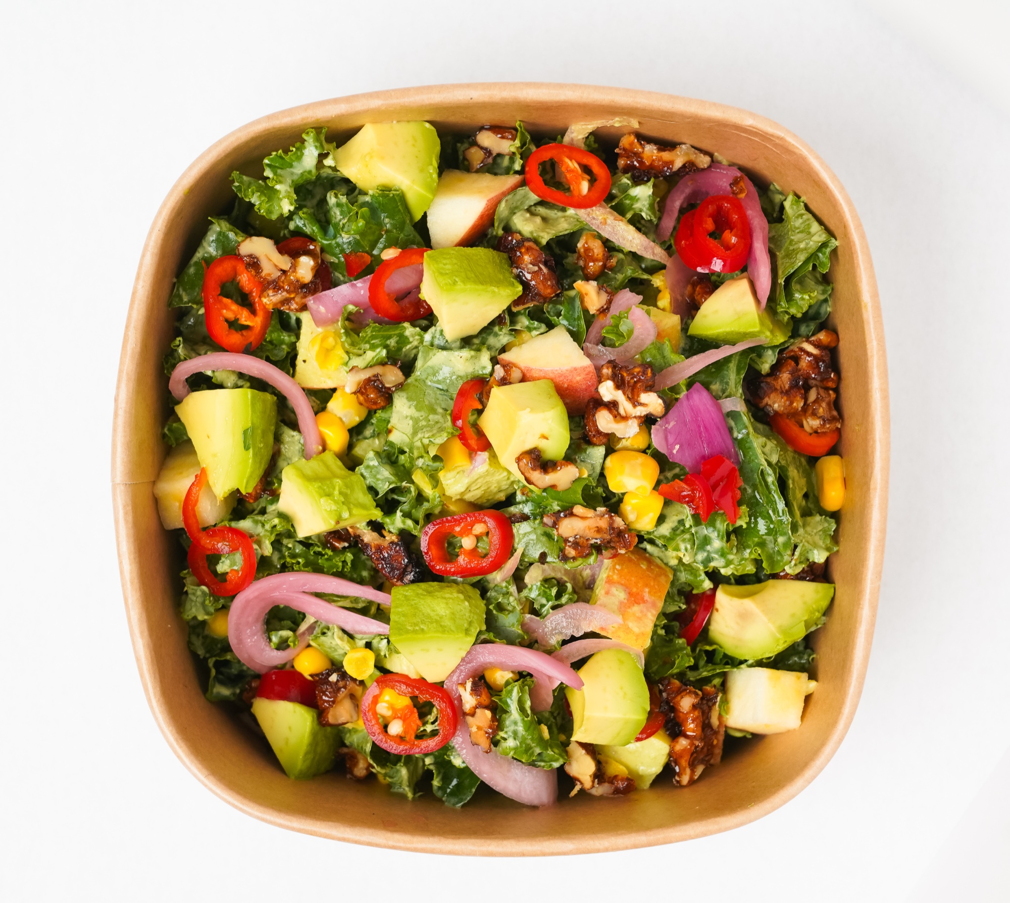 Honeybrains kale bowl with avocado, walnut, pickled onion, chili, corn